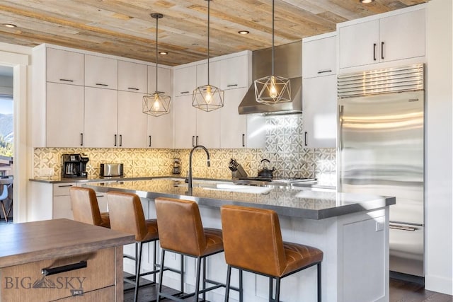 425 Outlook Trl, Big Sky, MT 59716 - kitchen featuring stainless steel built in refrigerator, wooden ceiling, a breakfast bar, pendant lighting, and backsplash