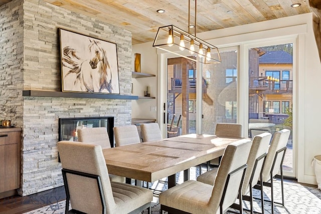 425 Outlook Trl, Big Sky, MT 59716 - dining area with wooden ceiling, healthy amount of natural light, wood finished floors, a stone fireplace, and recessed lighting
