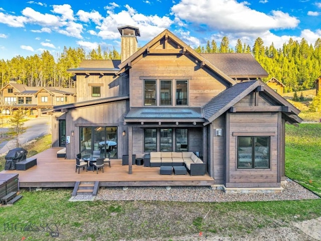 425 Outlook Trl, Big Sky, MT 59716 - rear view of property featuring outdoor lounge area, a wooden deck, a chimney, and a lawn