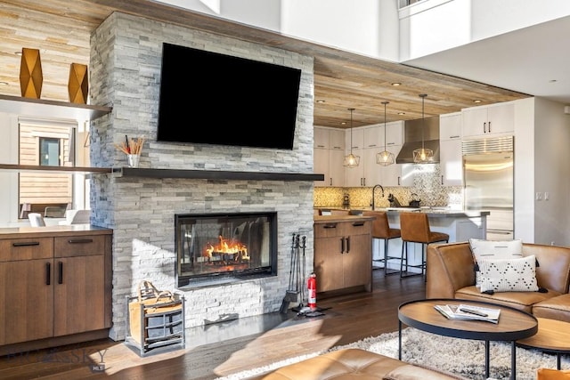 425 Outlook Trl, Big Sky, MT 59716 - living area with dark wood-type flooring and a stone fireplace