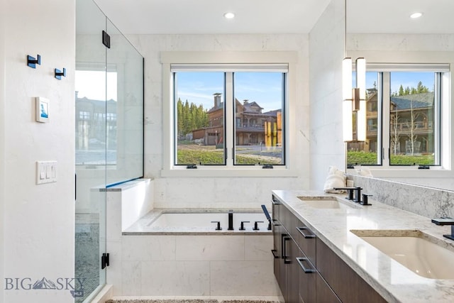 425 Outlook Trl, Big Sky, MT 59716 - bathroom with plenty of natural light, a bath, double vanity, a stall shower, and recessed lighting