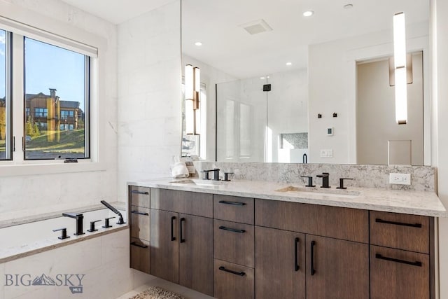 425 Outlook Trl, Big Sky, MT 59716 - bathroom with double vanity, a garden tub, a shower stall, and decorative backsplash