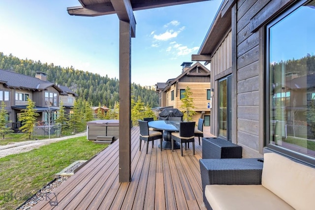425 Outlook Trl, Big Sky, MT 59716 - wooden terrace featuring a hot tub, outdoor dining space, and a yard