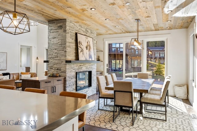 425 Outlook Trl, Big Sky, MT 59716 - dining area with wooden ceiling, a chandelier, wood finished floors, a fireplace, and recessed lighting
