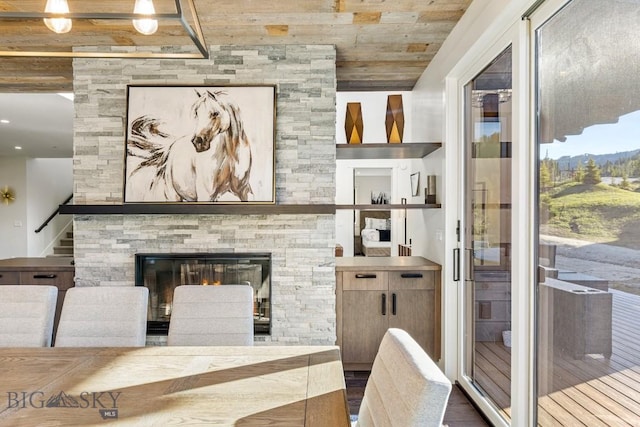 425 Outlook Trl, Big Sky, MT 59716 - living area with wooden ceiling, stairs, a mountain view, and a fireplace