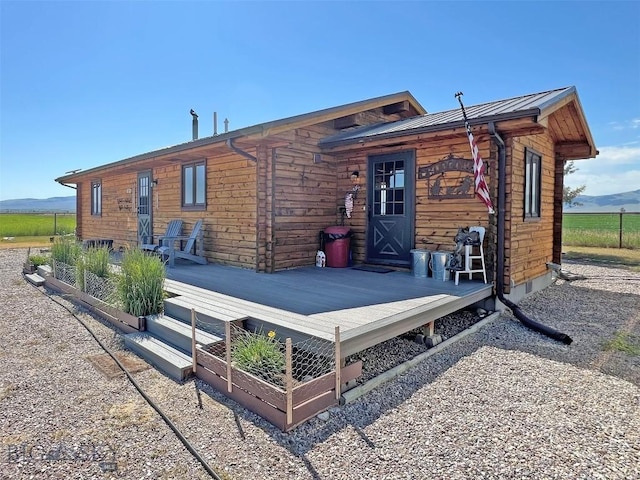 143 Aurora Ln, Dillon, MT 59725 - rear view of house with a wooden deck, a metal roof, and a standing seam roof