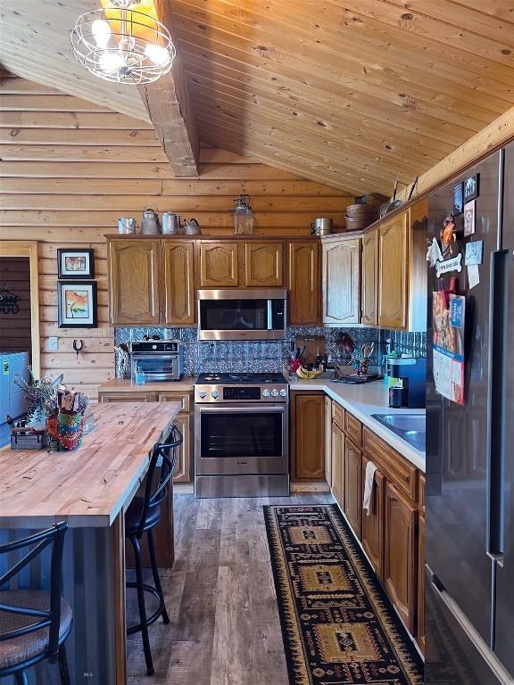 143 Aurora Ln, Dillon, MT 59725 - kitchen with stainless steel appliances, vaulted ceiling, butcher block counters, wood ceiling, and dark wood-type flooring