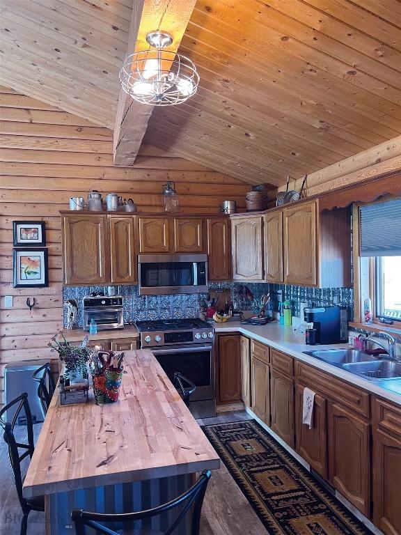 143 Aurora Ln, Dillon, MT 59725 - kitchen featuring appliances with stainless steel finishes, wood counters, wooden ceiling, vaulted ceiling, and dark wood-style flooring