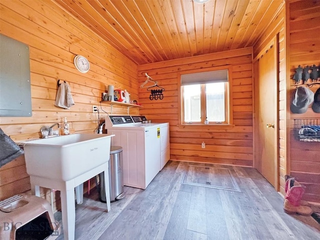 143 Aurora Ln, Dillon, MT 59725 - laundry area with independent washer and dryer, wooden ceiling, wood walls, light wood-style floors, and electric panel