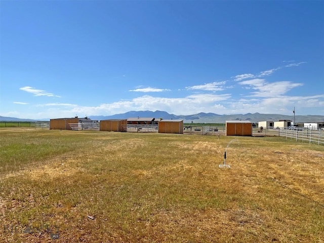 143 Aurora Ln, Dillon, MT 59725 - view of yard featuring a mountain view, an outbuilding, and a view of rural / pastoral area