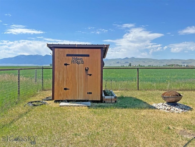 143 Aurora Ln, Dillon, MT 59725 - view of outbuilding featuring a fire pit, a mountain view, and a view of countryside