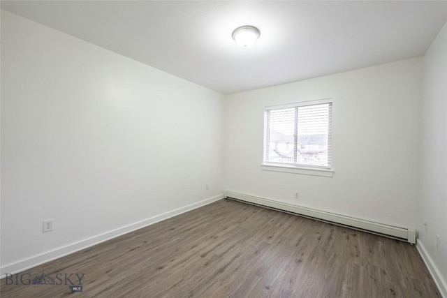 1010 Cruiser Ln Unit M, Belgrade, MT 59714 - spare room with a baseboard radiator and wood finished floors