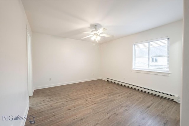1010 Cruiser Ln Unit M, Belgrade, MT 59714 - unfurnished room with a baseboard radiator, a ceiling fan, and wood finished floors