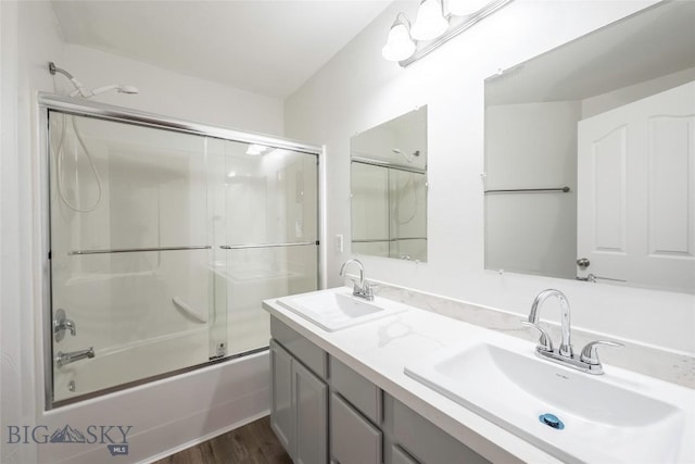 1010 Cruiser Ln Unit M, Belgrade, MT 59714 - bathroom featuring enclosed tub / shower combo, double vanity, and wood finished floors