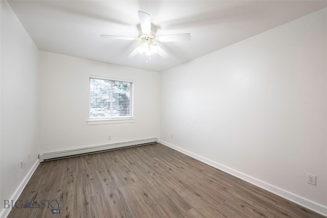 1010 Cruiser Ln Unit M, Belgrade, MT 59714 - spare room featuring baseboard heating, wood finished floors, and a ceiling fan