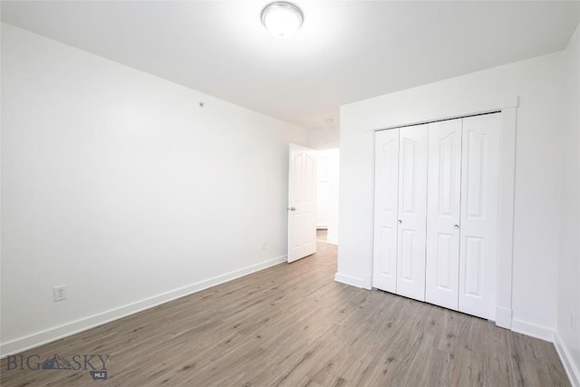1010 Cruiser Ln Unit M, Belgrade, MT 59714 - unfurnished bedroom featuring wood finished floors and a closet