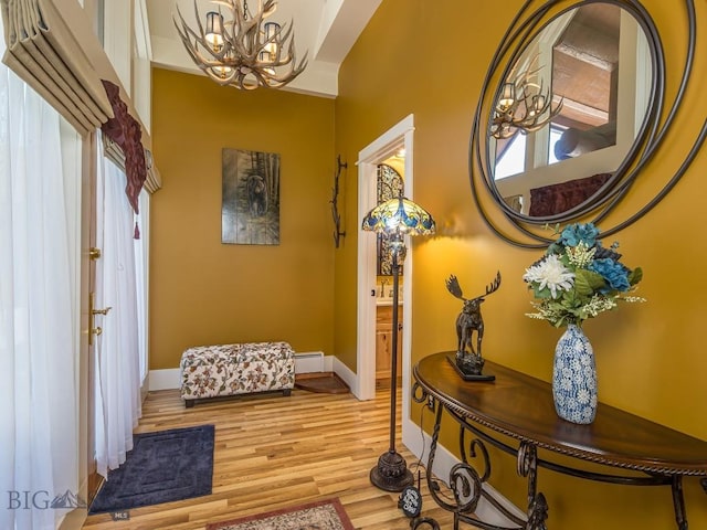 80 Crail Creek Ct Unit 616, Big Sky, MT 59716 - entryway with a chandelier, light wood-style floors, and a baseboard heating unit