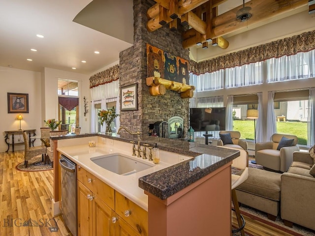 80 Crail Creek Ct Unit 616, Big Sky, MT 59716 - kitchen with open floor plan, dishwasher, light wood-style floors, recessed lighting, and a fireplace
