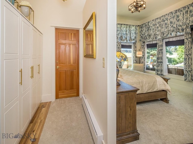 80 Crail Creek Ct Unit 616, Big Sky, MT 59716 - bedroom with baseboard heating, light carpet, and a closet