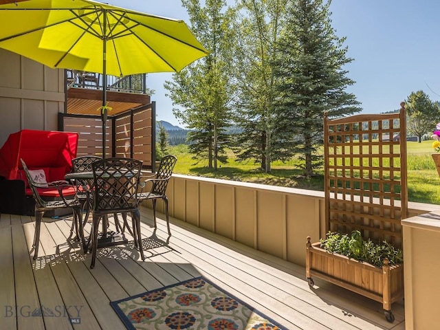 80 Crail Creek Ct Unit 616, Big Sky, MT 59716 - wooden deck featuring outdoor dining area and a mountain view