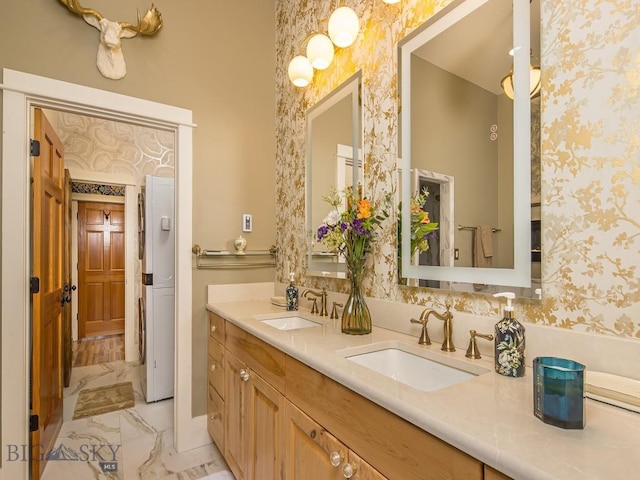 80 Crail Creek Ct Unit 616, Big Sky, MT 59716 - bathroom featuring wallpapered walls, marble look tiles, and double vanity