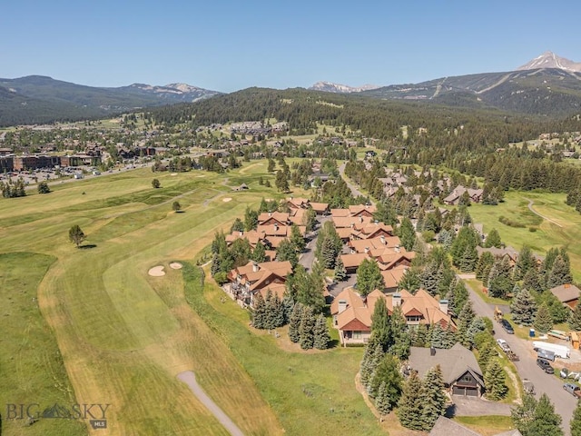 80 Crail Creek Ct Unit 616, Big Sky, MT 59716 - aerial view of property's location with a mountainous background, nearby suburban area, and a local golf course