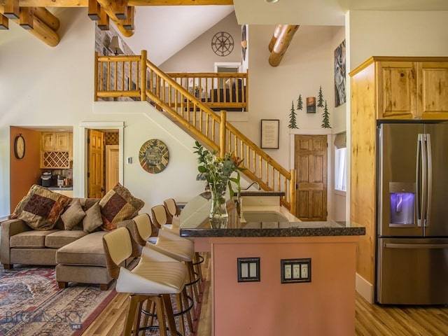 80 Crail Creek Ct Unit 616, Big Sky, MT 59716 - living area with high vaulted ceiling, wood finished floors, stairway, and beam ceiling