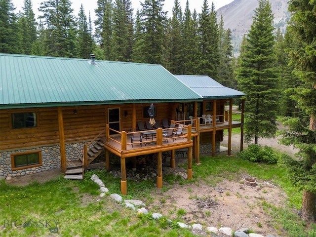 6 Arrowpoint, Silver Gate, MT 59081 - back of property featuring log exterior, a metal roof, stairway, and a deck with mountain view
