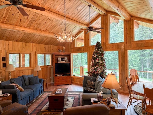 6 Arrowpoint, Silver Gate, MT 59081 - living area with ceiling fan, plenty of natural light, a wood ceiling with exposed beams, wooden walls, and high vaulted ceiling
