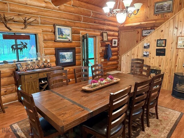 6 Arrowpoint, Silver Gate, MT 59081 - dining room with rustic walls, wood finished floors, healthy amount of natural light, and a chandelier