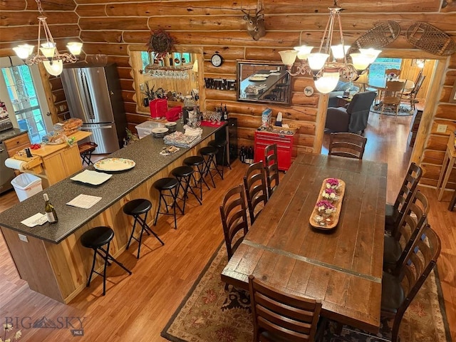 6 Arrowpoint, Silver Gate, MT 59081 - dining room with a chandelier, log walls, and light wood finished floors