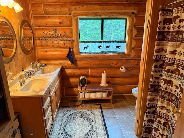 6 Arrowpoint, Silver Gate, MT 59081 - bathroom with rustic walls, double vanity, and tile patterned floors
