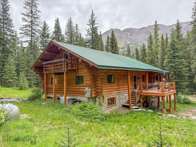 6 Arrowpoint, Silver Gate, MT 59081 - back of property featuring log exterior, a mountain view, a view of trees, and a metal roof