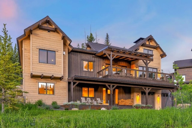 580 Outlook Trl Unit 42, Big Sky, MT 59730 - back of property at dusk with a balcony and board and batten siding