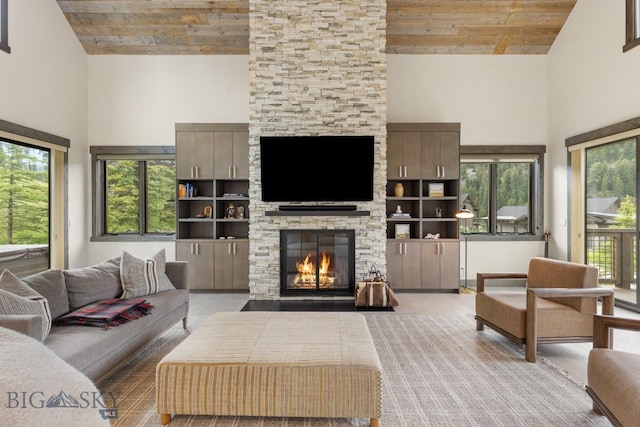 580 Outlook Trl Unit 42, Big Sky, MT 59730 - living room featuring a towering ceiling, wooden ceiling, a stone fireplace, and wood finished floors