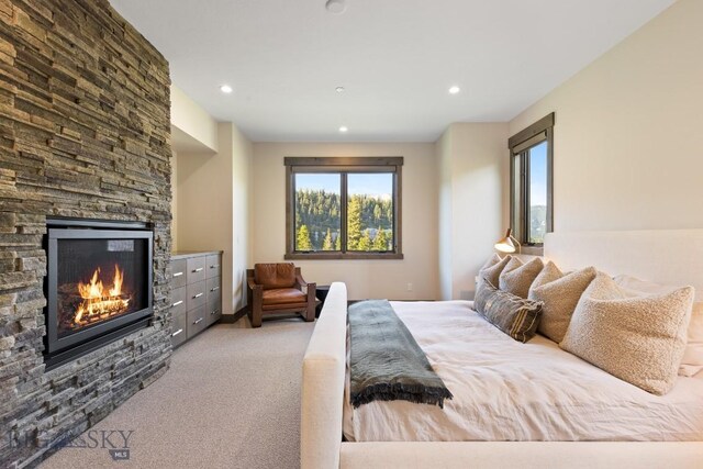 580 Outlook Trl Unit 42, Big Sky, MT 59730 - bedroom with a stone fireplace, recessed lighting, and carpet
