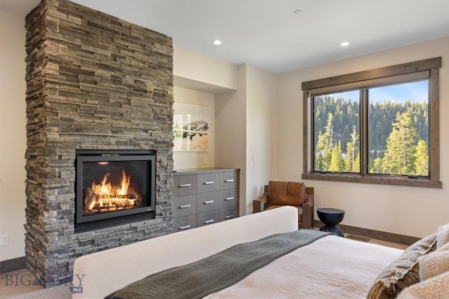 580 Outlook Trl Unit 42, Big Sky, MT 59730 - bedroom with a stone fireplace and recessed lighting