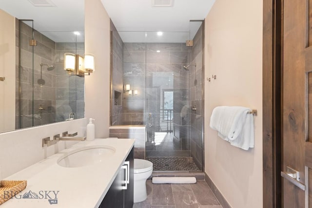580 Outlook Trl Unit 42, Big Sky, MT 59730 - bathroom featuring vanity, marble finish flooring, a shower stall, and recessed lighting