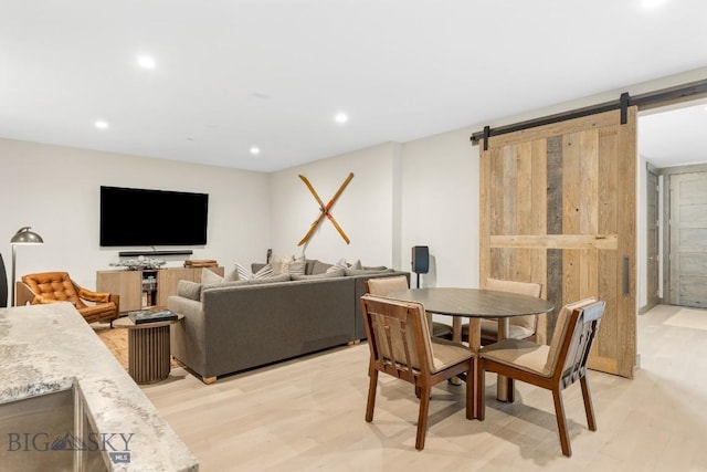 580 Outlook Trl Unit 42, Big Sky, MT 59730 - dining room with a barn door, recessed lighting, and light wood-style flooring