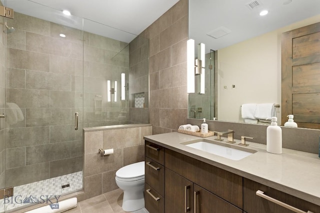 580 Outlook Trl Unit 42, Big Sky, MT 59730 - bathroom featuring vanity, tile walls, a stall shower, tile patterned flooring, and recessed lighting