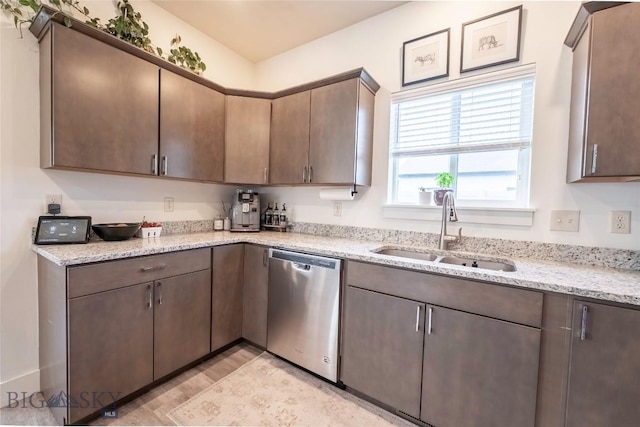 1306 Scooter Ln, Belgrade, MT 59714 - kitchen featuring dishwasher, light stone countertops, and dark brown cabinets