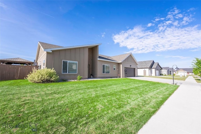 1306 Scooter Ln, Belgrade, MT 59714 - view of front of home with board and batten siding, concrete driveway, and a garage