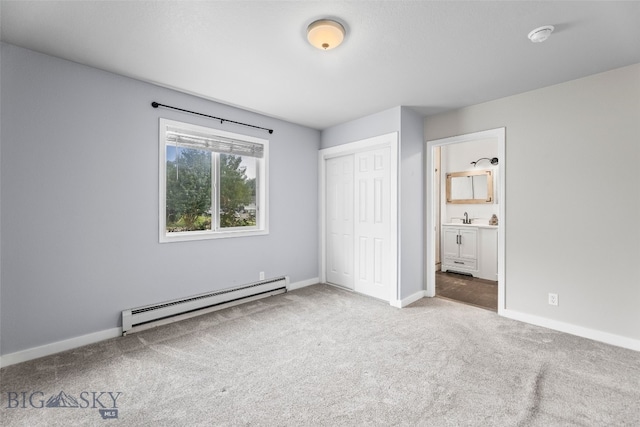 1304 Absaroka Ct, Livingston, MT 59047 - unfurnished bedroom featuring a baseboard heating unit, carpet floors, a closet, and ensuite bath
