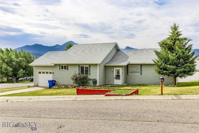 1304 Absaroka Ct, Livingston, MT 59047 - view of front facade featuring a garage, concrete driveway, a front yard, and a mountain view