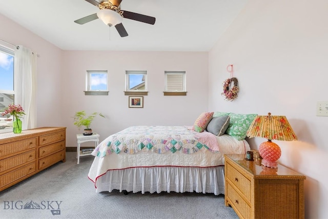 182 Snowy Owl Trl, Bozeman, MT 59718 - bedroom with light colored carpet and a ceiling fan