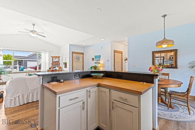 182 Snowy Owl Trl, Bozeman, MT 59718 - kitchen featuring wooden counters, open floor plan, light wood finished floors, lofted ceiling, and ceiling fan