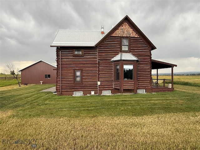 185 Howie Rd, Big Timber, MT 59011 - rear view of house with log exterior, a lawn, a metal roof, and crawl space