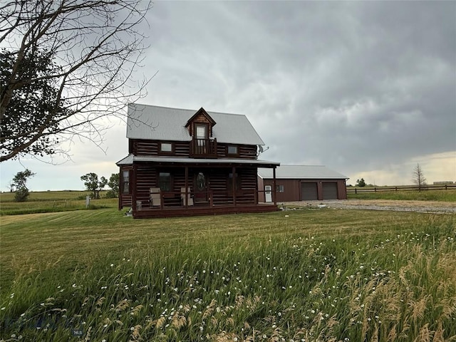 185 Howie Rd, Big Timber, MT 59011 - rear view of house featuring dirt driveway, a lawn, a metal roof, and a porch
