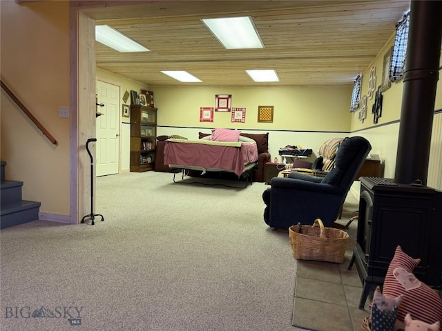 185 Howie Rd, Big Timber, MT 59011 - carpeted living room featuring a wood stove and stairway