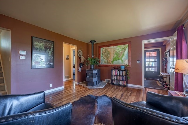 302 Ordway St S, Wilsall, MT 59086 - living room featuring a wood stove and wood finished floors